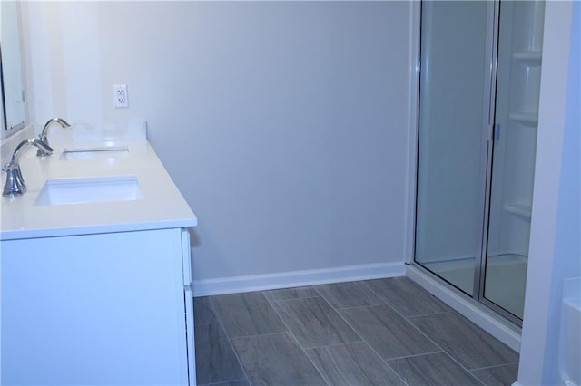 bathroom featuring vanity and a shower with shower door