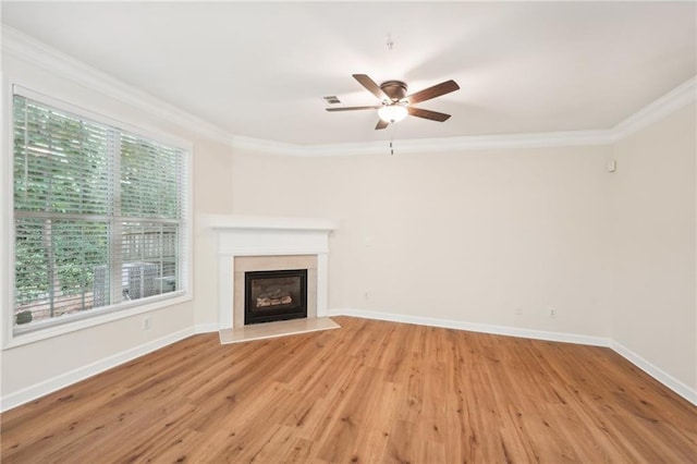 unfurnished living room featuring ornamental molding, ceiling fan, and light hardwood / wood-style flooring