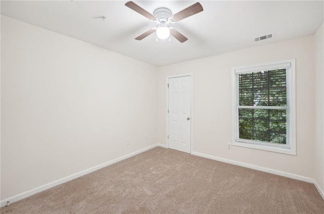 empty room featuring ceiling fan and carpet floors