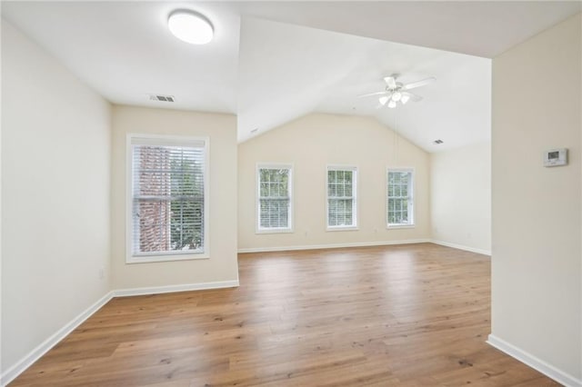 empty room with light wood-type flooring, lofted ceiling, and ceiling fan