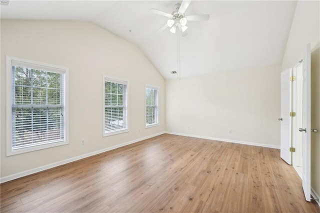 spare room with light hardwood / wood-style floors, vaulted ceiling, and ceiling fan