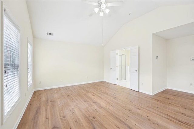 spare room with lofted ceiling, ceiling fan, and light hardwood / wood-style flooring