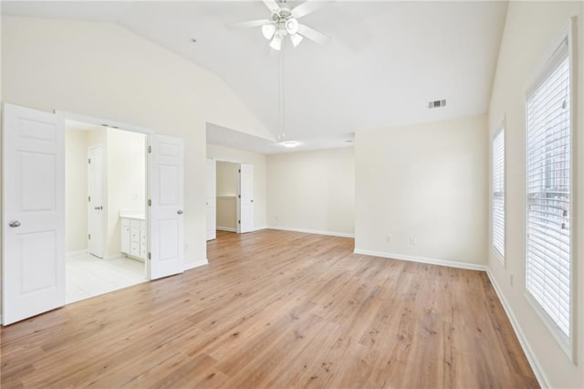 unfurnished bedroom featuring ceiling fan, ensuite bath, light hardwood / wood-style floors, and multiple windows