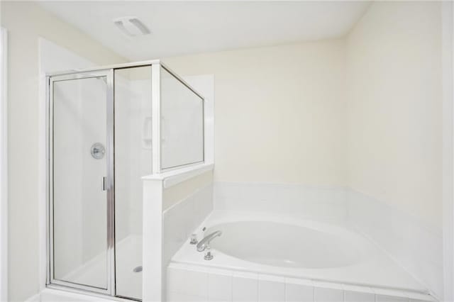 bathroom featuring separate shower and tub