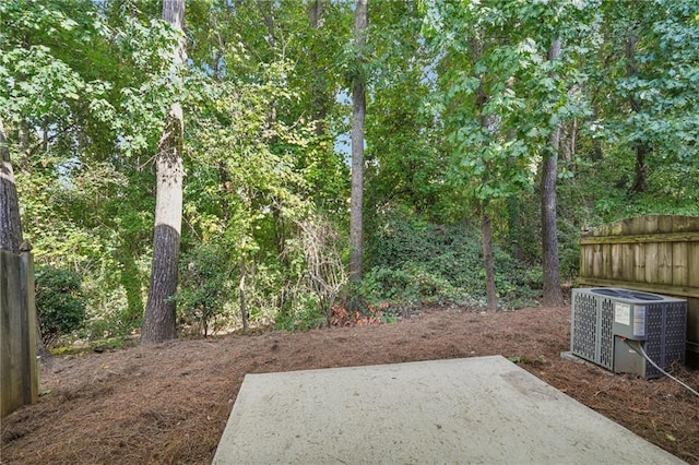 view of yard featuring central AC unit and a patio area