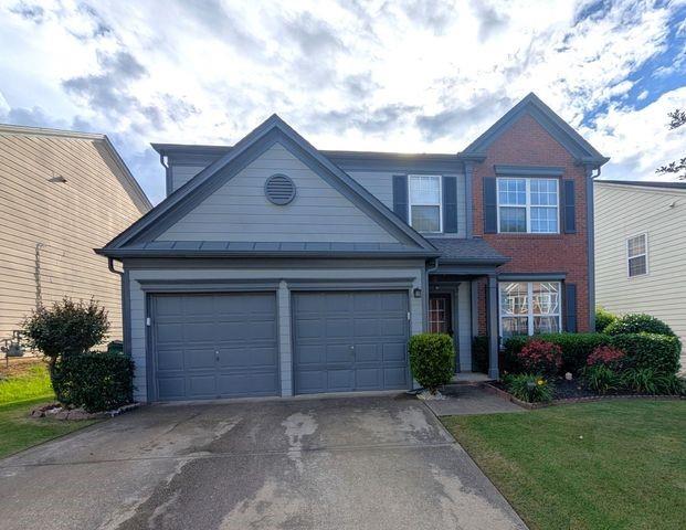 640 Dahoma Trl, Woodstock, GA 30188 - traditional home with concrete driveway, a garage, and a front lawn