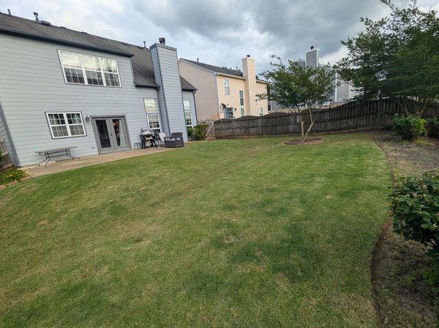 640 Dahoma Trl, Woodstock, GA 30188 - fenced backyard with french doors and a patio area