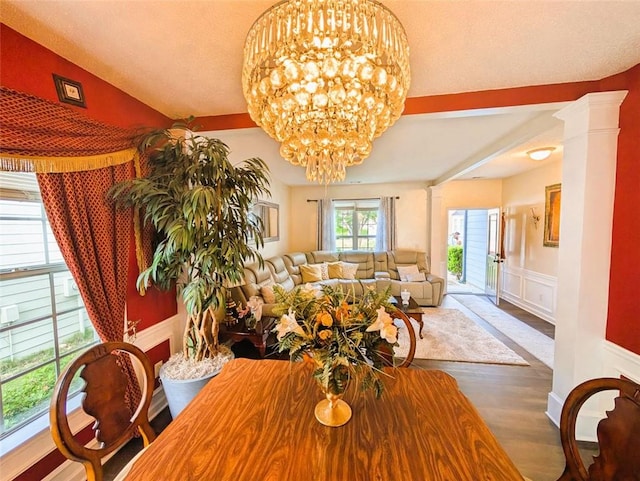 640 Dahoma Trl, Woodstock, GA 30188 - dining area featuring a chandelier, wood finished floors, wainscoting, and a decorative wall