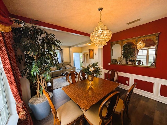 640 Dahoma Trl, Woodstock, GA 30188 - dining room featuring a chandelier, wood finished floors, healthy amount of natural light, and a wainscoted wall