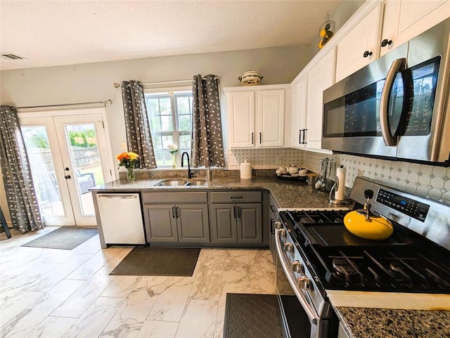 640 Dahoma Trl, Woodstock, GA 30188 - kitchen with appliances with stainless steel finishes, light marble finish floors, white cabinetry, french doors, and tasteful backsplash