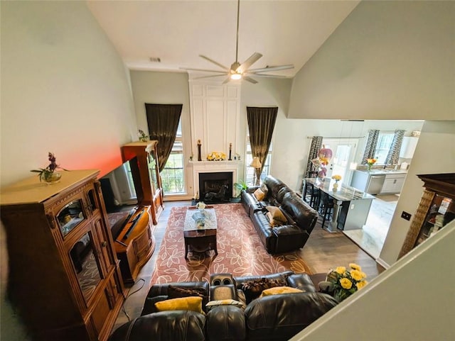 640 Dahoma Trl, Woodstock, GA 30188 - living area with high vaulted ceiling, a ceiling fan, a large fireplace, and wood finished floors