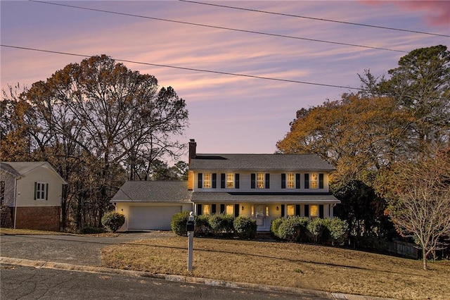 view of front facade with a garage and a porch