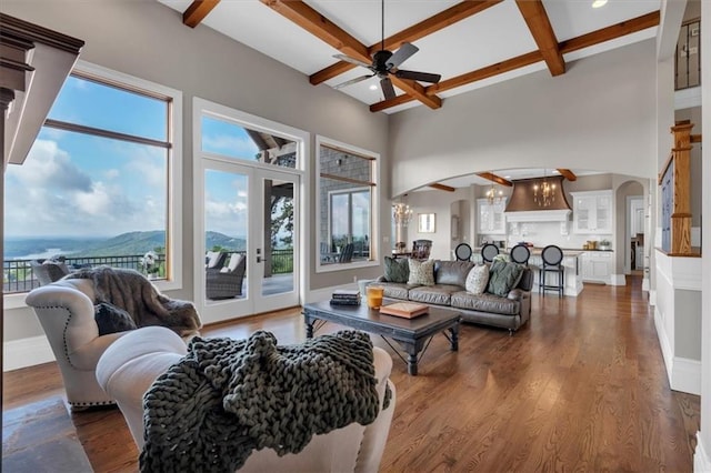 89 Somerset Ln, Cartersville, GA 30121 - living area featuring arched walkways, a ceiling fan, coffered ceiling, a chandelier, and beamed ceiling