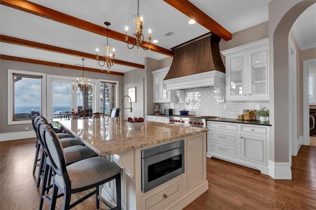 89 Somerset Ln, Cartersville, GA 30121 - kitchen featuring a chandelier, stainless steel appliances, beamed ceiling, tasteful backsplash, and dark wood-style floors