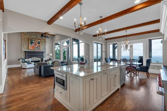 89 Somerset Ln, Cartersville, GA 30121 - kitchen featuring a chandelier, a sink, stainless steel appliances, a stone fireplace, and a ceiling fan