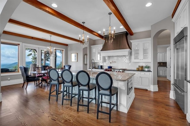 89 Somerset Ln, Cartersville, GA 30121 - kitchen featuring a chandelier, built in refrigerator, custom exhaust hood, backsplash, and beam ceiling