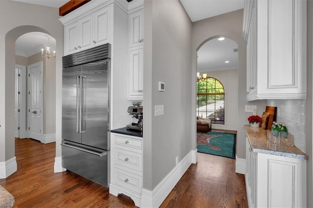 89 Somerset Ln, Cartersville, GA 30121 - kitchen featuring stainless steel built in fridge, arched walkways, a chandelier, dark wood-style floors, and baseboards