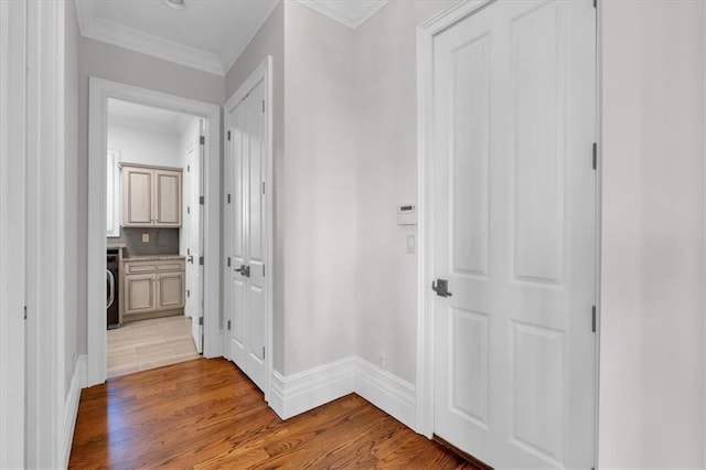 89 Somerset Ln, Cartersville, GA 30121 - hall featuring light wood finished floors, ornamental molding, washer / dryer, and baseboards