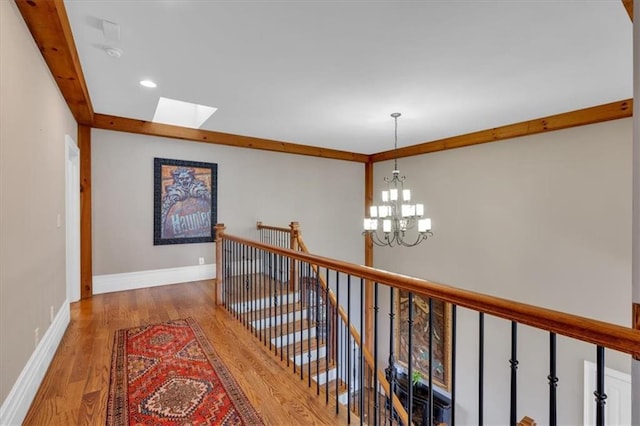 89 Somerset Ln, Cartersville, GA 30121 - hall featuring wood finished floors, a skylight, a chandelier, an upstairs landing, and recessed lighting