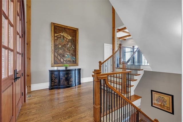 89 Somerset Ln, Cartersville, GA 30121 - foyer entrance featuring light wood finished floors, baseboards, high vaulted ceiling, beamed ceiling, and stairway