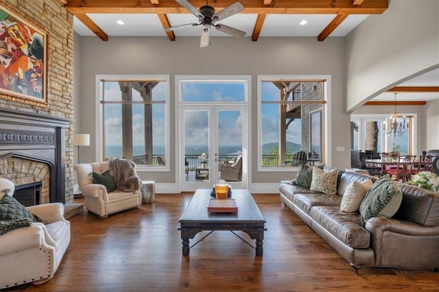 89 Somerset Ln, Cartersville, GA 30121 - living area featuring a chandelier, beamed ceiling, a large fireplace, a ceiling fan, and wood finished floors