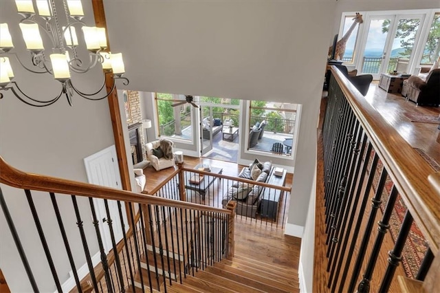 89 Somerset Ln, Cartersville, GA 30121 - staircase with wood finished floors, plenty of natural light, a chandelier, and a ceiling fan