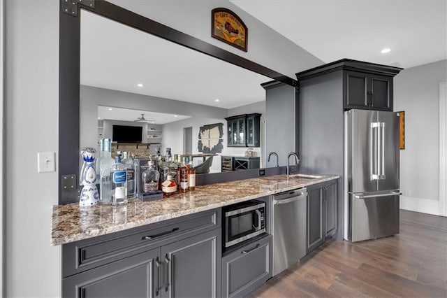 89 Somerset Ln, Cartersville, GA 30121 - kitchen featuring appliances with stainless steel finishes, a sink, light stone countertops, dark wood finished floors, and recessed lighting