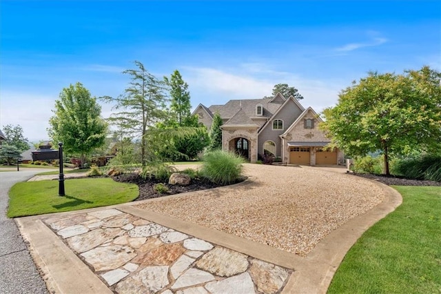 89 Somerset Ln, Cartersville, GA 30121 - french provincial home featuring curved driveway, a front lawn, brick siding, and a garage