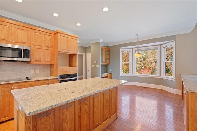 kitchen with light hardwood / wood-style flooring, a center island, and stainless steel appliances