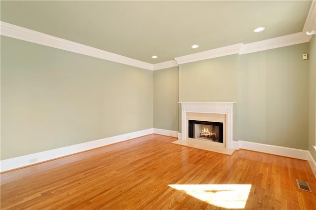 unfurnished living room featuring light hardwood / wood-style flooring and ornamental molding