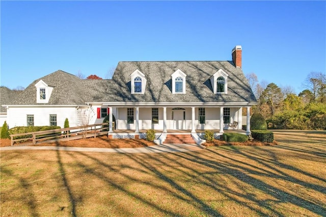 cape cod-style house featuring a porch and a front yard