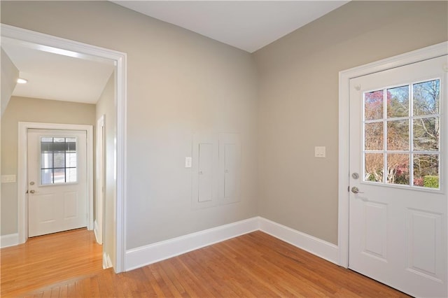 entryway with light hardwood / wood-style floors and a healthy amount of sunlight