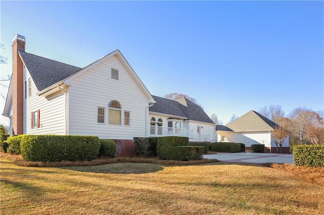 rear view of property with a lawn