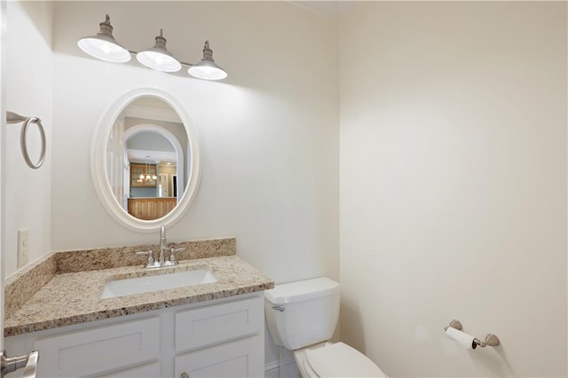 bathroom featuring vanity with extensive cabinet space and toilet