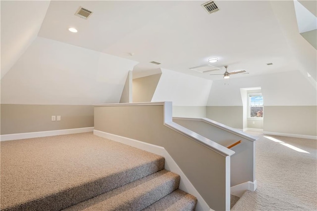 staircase with lofted ceiling, light colored carpet, and ceiling fan