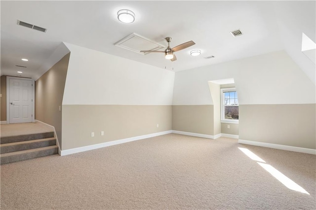 additional living space featuring light carpet, lofted ceiling, and ceiling fan