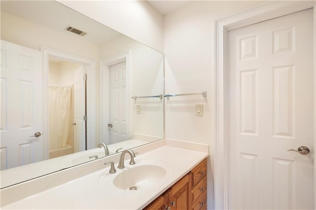 bathroom with vanity and shower / tub combo with curtain