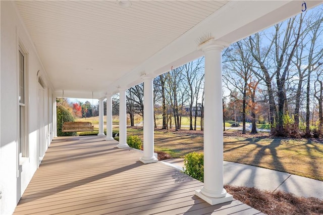 wooden deck with a lawn