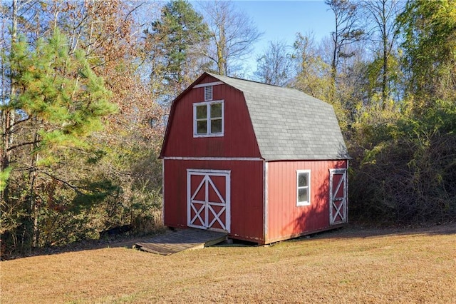 view of outdoor structure featuring a lawn