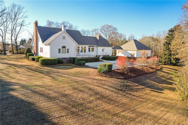 cape cod home with a front yard and central air condition unit