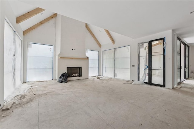 unfurnished living room featuring high vaulted ceiling, a fireplace, and beamed ceiling