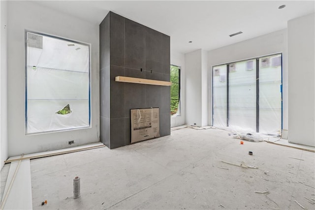 unfurnished living room featuring visible vents