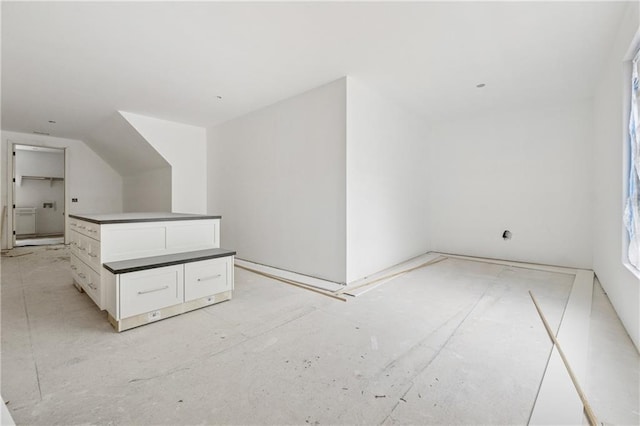 additional living space featuring lofted ceiling