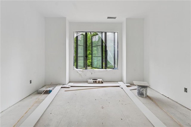 unfurnished room featuring visible vents
