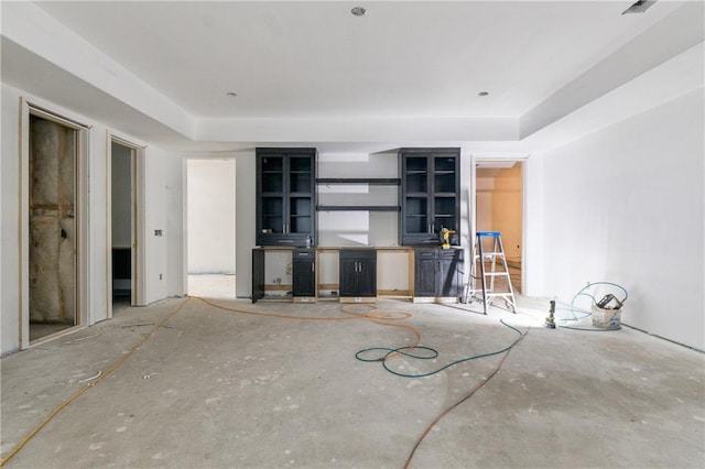 unfurnished living room with a tray ceiling