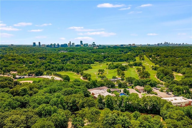 birds eye view of property featuring a forest view and a city view