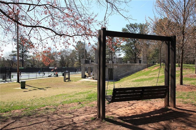 view of community featuring fence and a lawn