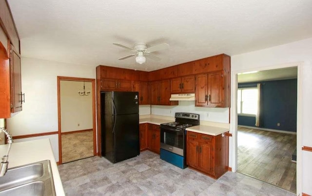 290 Timber Ridge Trl, Carrollton, GA 30117 - kitchen with freestanding refrigerator, electric range, under cabinet range hood, light floors, and light countertops