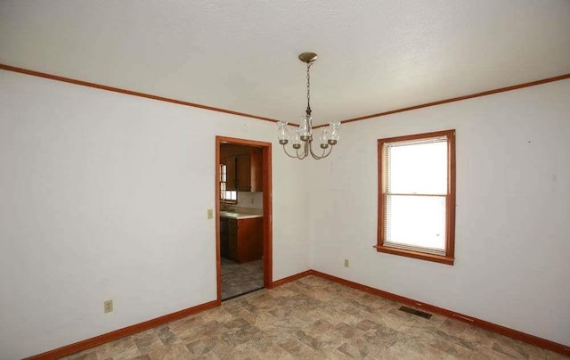 290 Timber Ridge Trl, Carrollton, GA 30117 - spare room with a chandelier, stone finish flooring, and crown molding