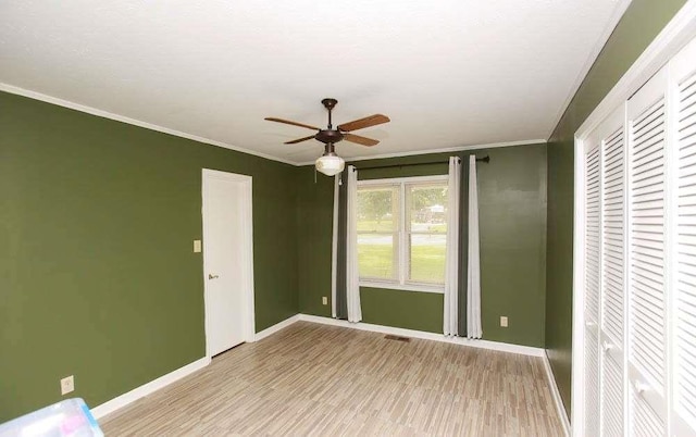 290 Timber Ridge Trl, Carrollton, GA 30117 - unfurnished bedroom featuring light wood-type flooring, ornamental molding, a ceiling fan, and a closet